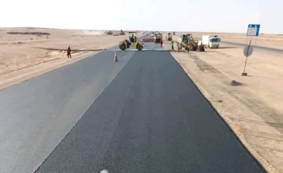 Fresh asphalt layer seen from the paver deck during road paving