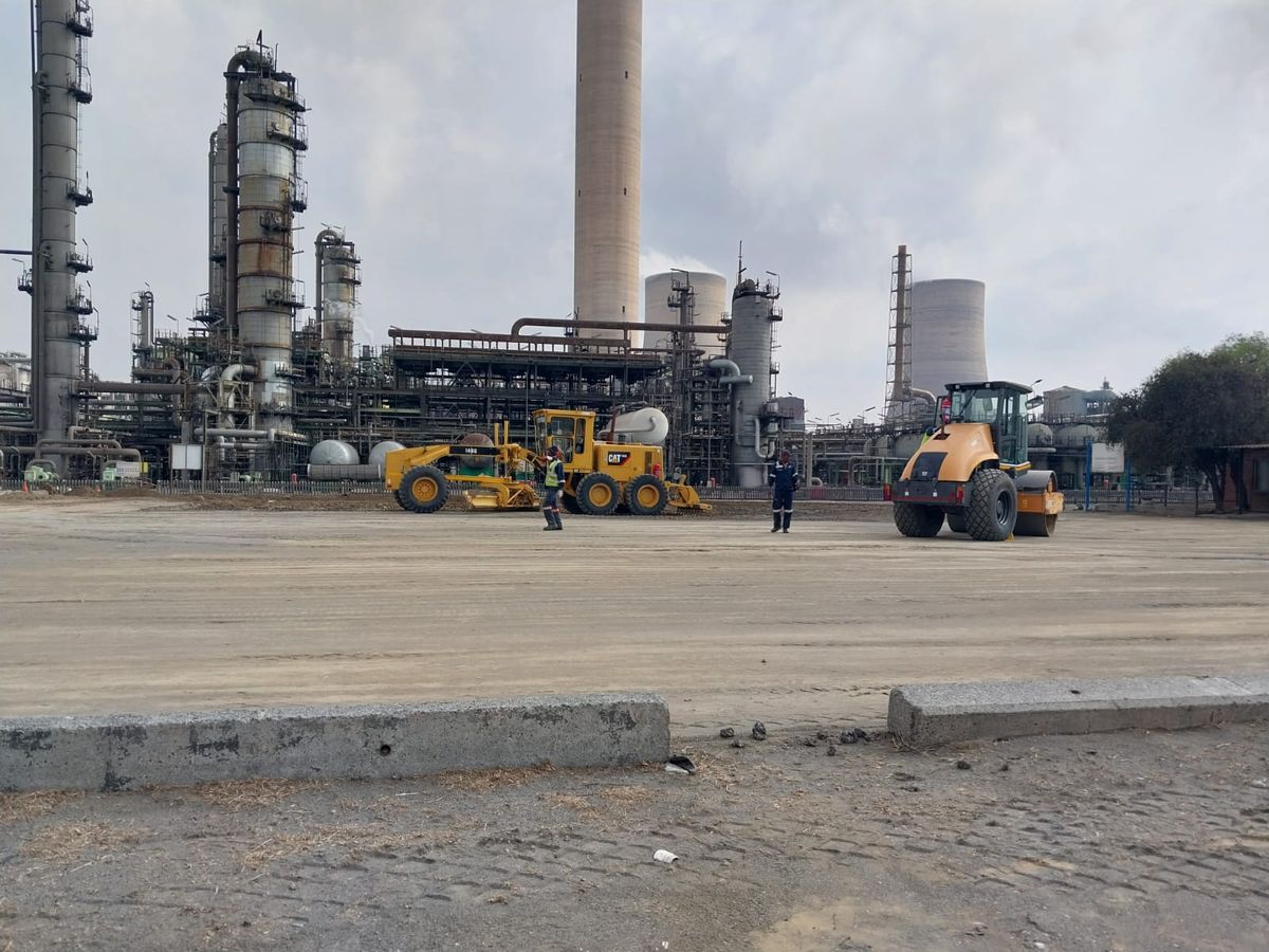 Grader and roller doing earthworks at an industrial refinery